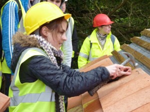 Volunteer student architect, Natalia Krysiak trying her hand Rosemary tiling